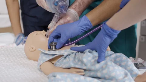 CPR. Professionals using a baby simulator to practice proper procedures 스톡 동영상 278460635