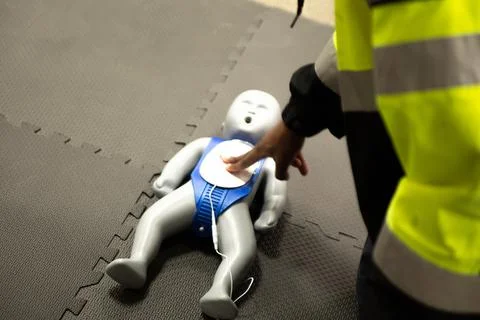 CPR training class by security guard in office Stock Photos