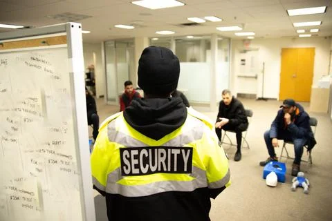 CPR training class by security guard in office Stock Photos