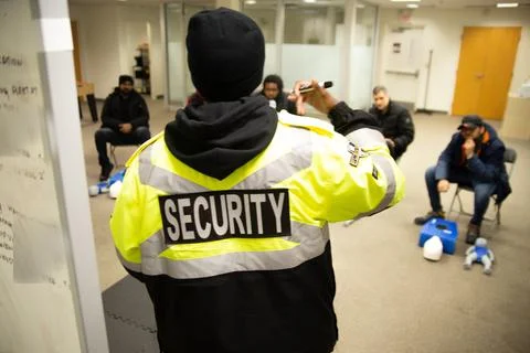 CPR training class by security guard in office Stock Photos