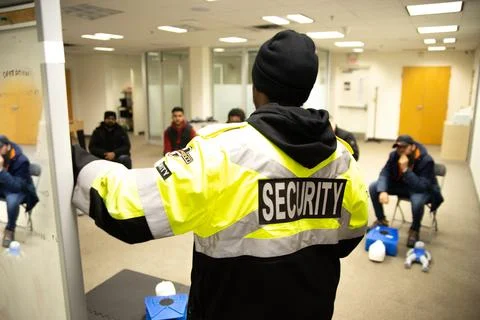 CPR training class by security guard in office Stock Photos
