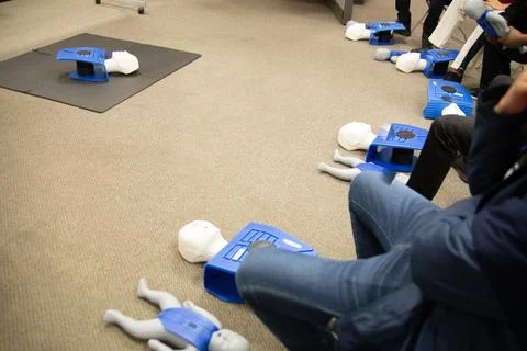 CPR training class by security guard in office Stock Photos