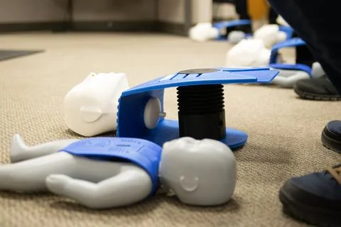CPR training class by security guard in office Stock Photos