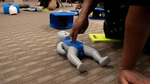 CPR training class by security guard in office Stock Photos