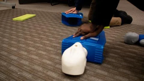 CPR training class by security guard in office Stock Photos