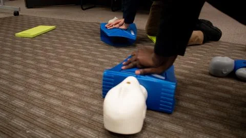 CPR training class by security guard in office Stock Photos