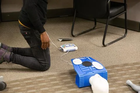 CPR training class by security guard in office Stock Photos