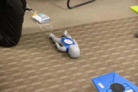 CPR training class by security guard in office Stock Photos