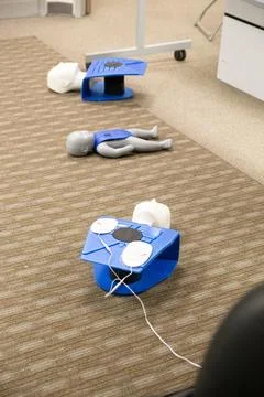 CPR training class by security guard in office Stock Photos