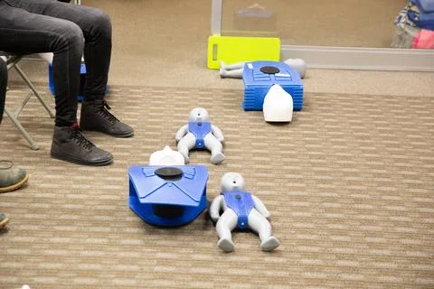CPR training class by security guard in office Stock Photos