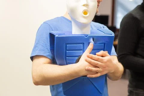 CPR training class by security guard in office Stock Photos