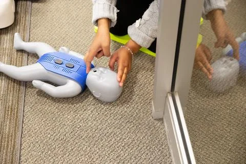 CPR training class by security guard in office Stock Photos