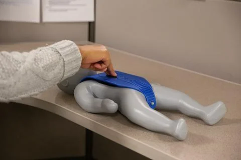 CPR training class by security guard in office Stock Photos