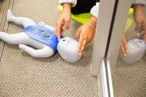 CPR training class by security guard in office 스톡 사진