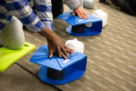 CPR training class by security guard in office Stock Photos