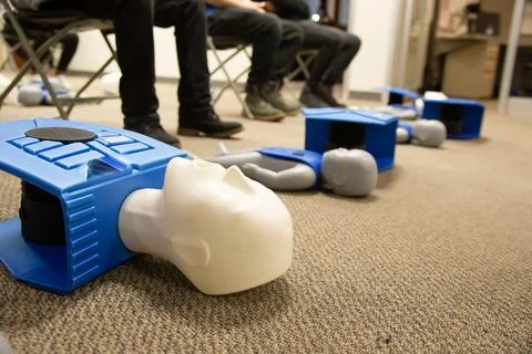 CPR training class by security guard in office Stock Photos