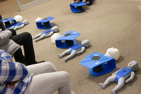 CPR training class by security guard in office Stock Photos