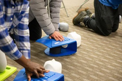 CPR training class by security guard in office 스톡 사진
