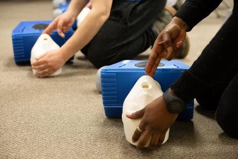 CPR training class by security guard in office 스톡 사진