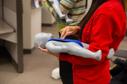 CPR training class by security guard in office Stock Photos