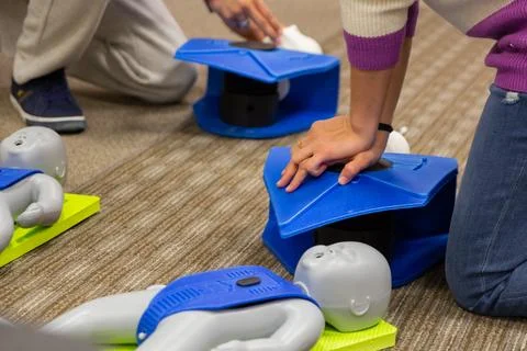 CPR training class by security guard in office Stock Photos