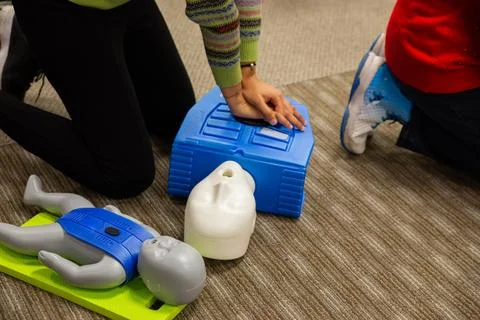 CPR training class by security guard in office Stock Photos