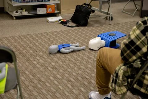 CPR training class by security guard in office 스톡 사진