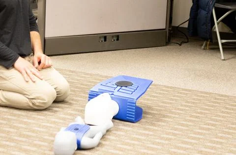 CPR training class by security guard in office Stock Photos