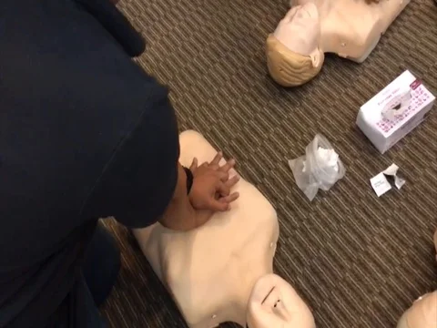 CPR Training Demonstrating Chest Compression On A Dummy Stock Footage 73100288