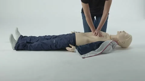 CPR training on mannequin white white background Stock Footage 220433585