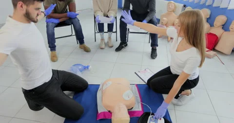 CPR training medical procedure workshop. Demonstrating chest compressions and Stock Footage 163975144