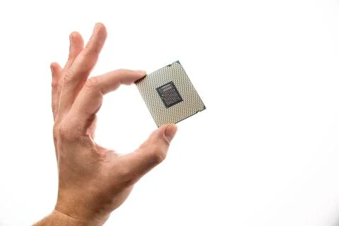 CPU backside in man's hand isolated on white background. Foto stock