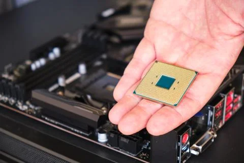 CPU (Central Processing Unit) held in a man's hand - close up 스톡 사진