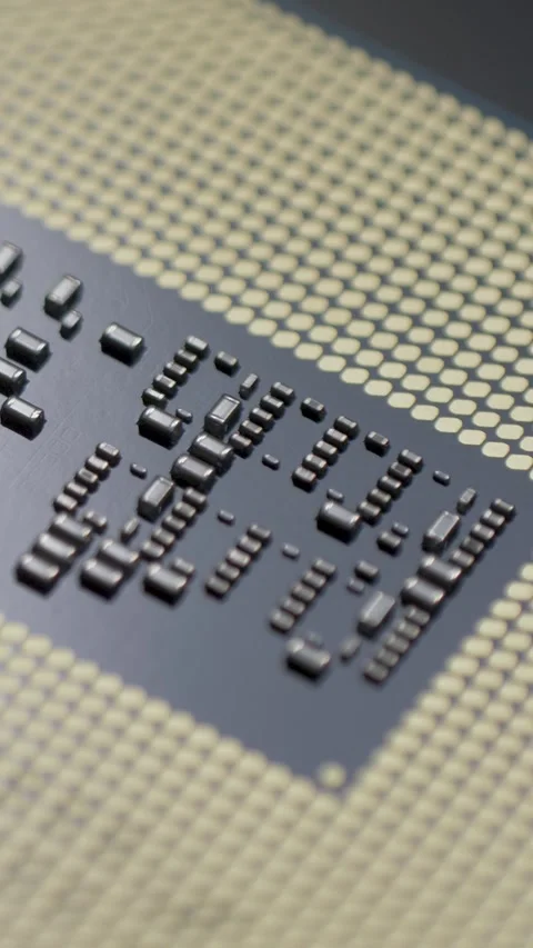 CPU chip base with gold contact pads and small dark capacitors Stock Footage 344245855