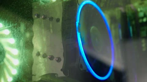 CPU cooler behind dusty computer case glass with RGB lighting. Macro view of Video stock 337642205