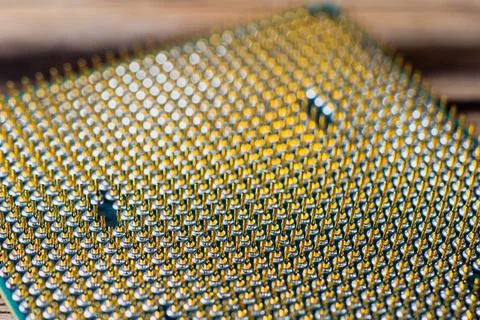 CPU desktop with the contacts facing up lying on the PC. the chip is highligh Stock Photos