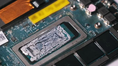 CPU with Dried Liquid Metal Thermal Compound on a Circuit Board Stock Footage 314013233