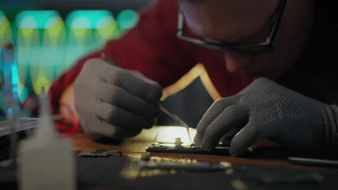 CPU. An electronic technician equipped with tools performs repair work in an Stock Footage 278411728