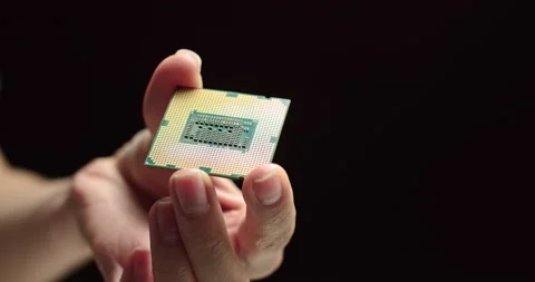 CPU in hands of a technician. The processor is being examined for apparent Stock Footage 144937635