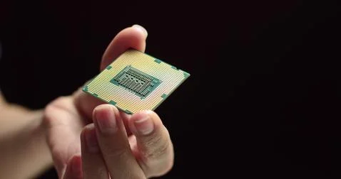 CPU in hands of a technician. The processor is being examined for apparent 写真素材