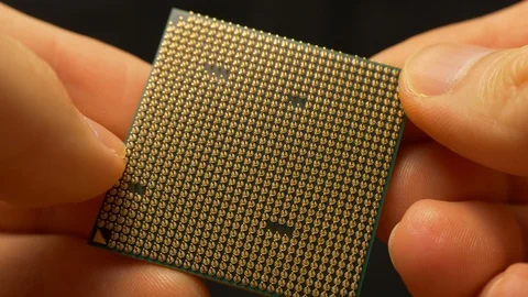 CPU macro hands holding processor (cca 2010 era PC CPU) Stock Footage 127656204