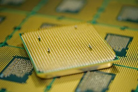 CPU with micro pins and solder pads visible for precise hardware installation Stock Photos