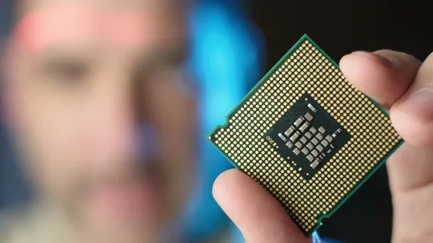 CPU microchip holding by male, scanning red light through his face, Focus Stock Footage 170458632
