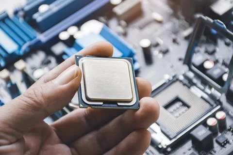 CPU processor chip in technician hand 스톡 사진
