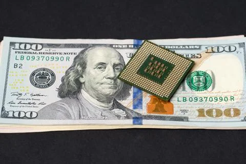 CPU processor on dollar bills. Transistors on central processing unit Stock Photos