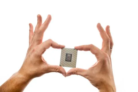 CPU's backside in man's hand isolated on white background. Stock Photos