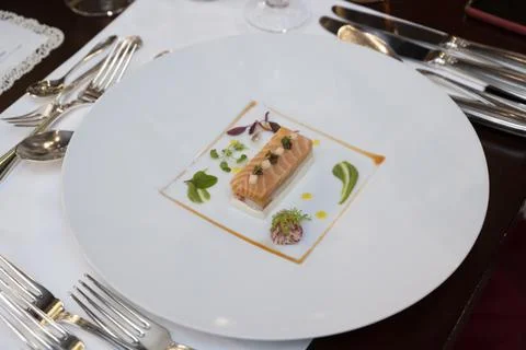 A crab is sandwiched between rectangular salmon terrines Stock-Fotos