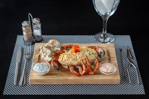 Crab shell stuffed with a paste made of egg, mayonnaise and crab meat, with two Foto stock