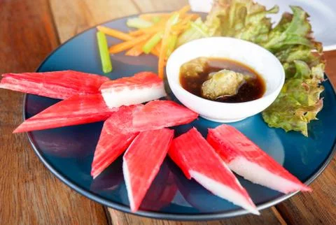 Crab stick on plate egetable lettuce salad crab stick wasabi sauce cup surimi Stock Photos