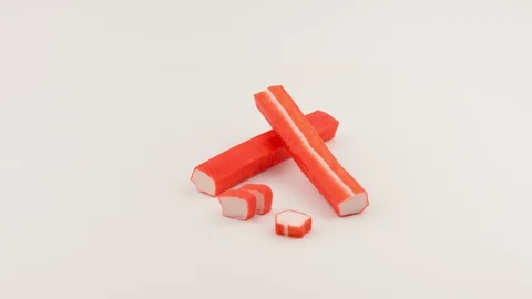 Crab sticks closeup. White background. Slow motion. Stockbeeldmateriaal 129693219